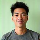 Portrait of David Chen, a fitness and stress management coach, with a supportive expression.