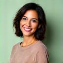 Portrait of Elena Ramirez, a professional wellness coach, smiling warmly.